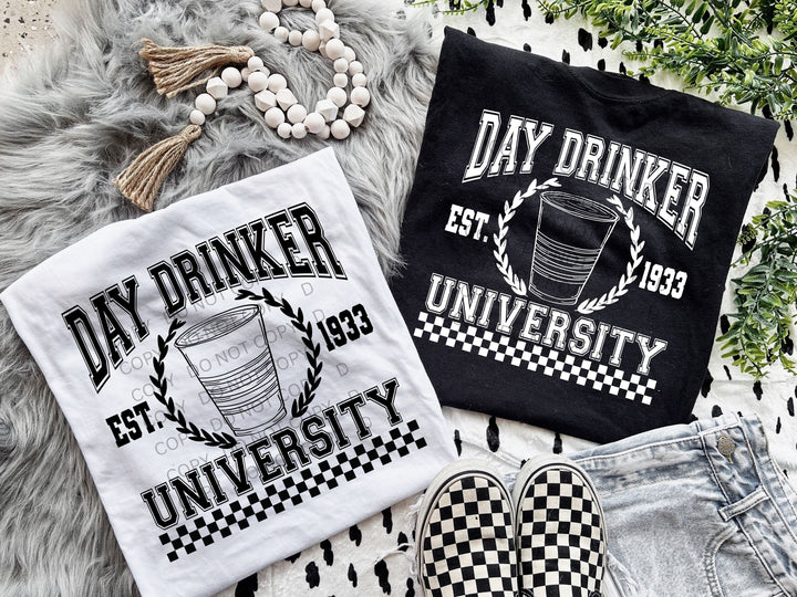 two t - shirts that say day drinker, eat university and a pair of