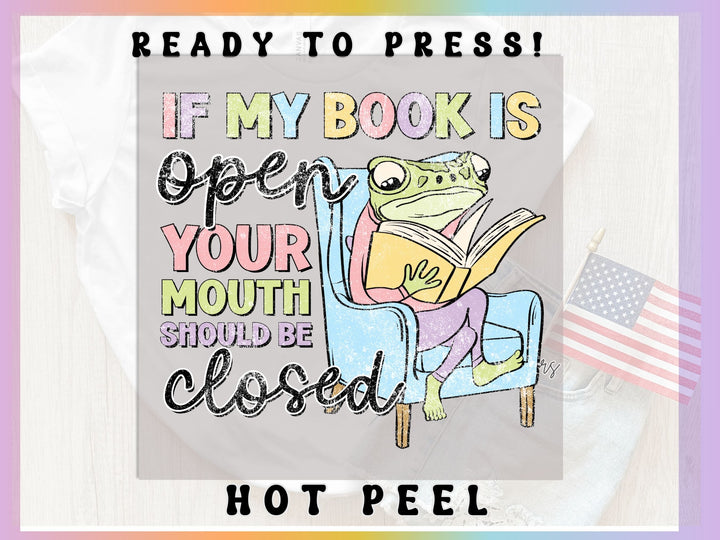 a picture of a frog reading a book