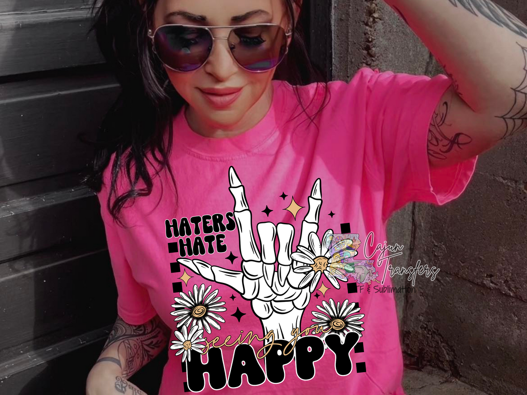 a woman wearing a pink shirt with a peace sign on it