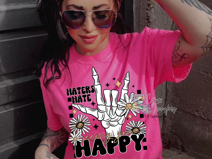a woman wearing a pink shirt with a peace sign on it