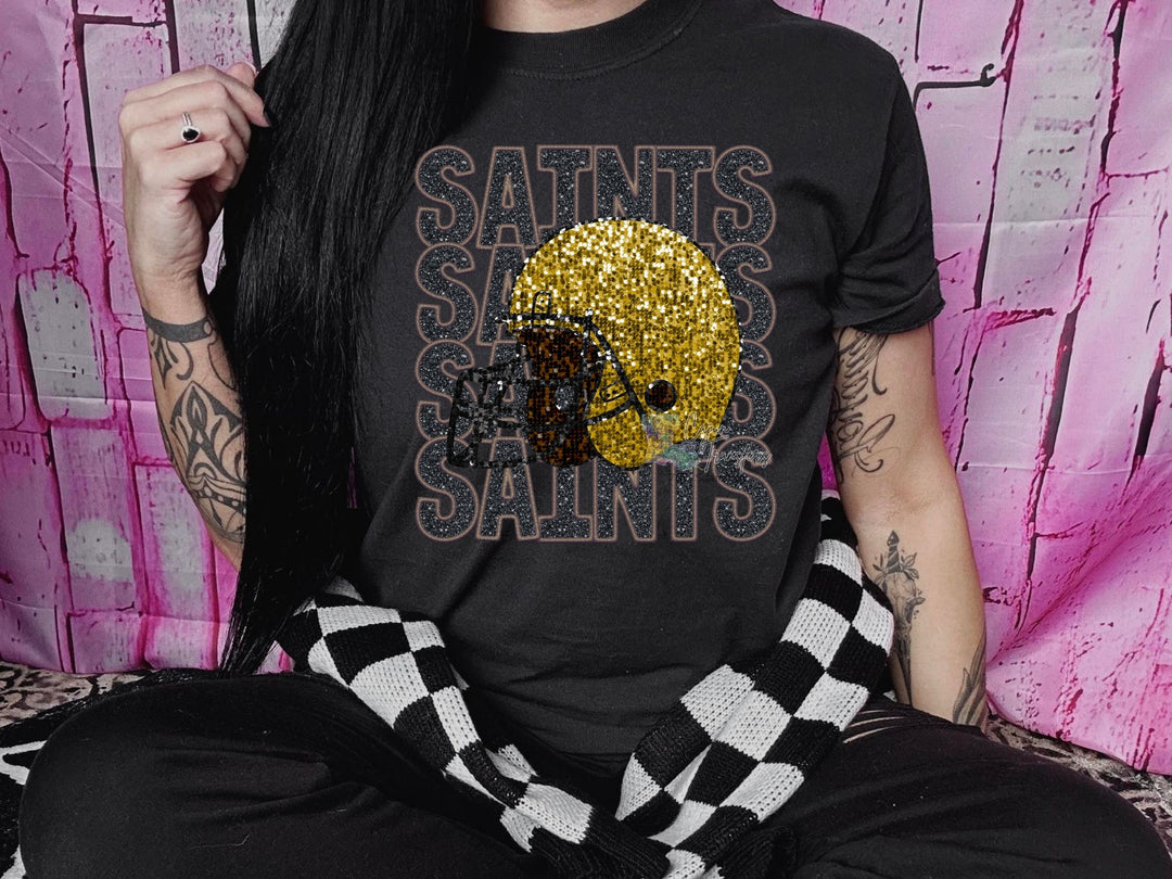 a woman with long black hair wearing a saints saints shirt