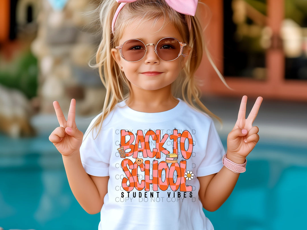a little girl wearing a shirt that says back to school