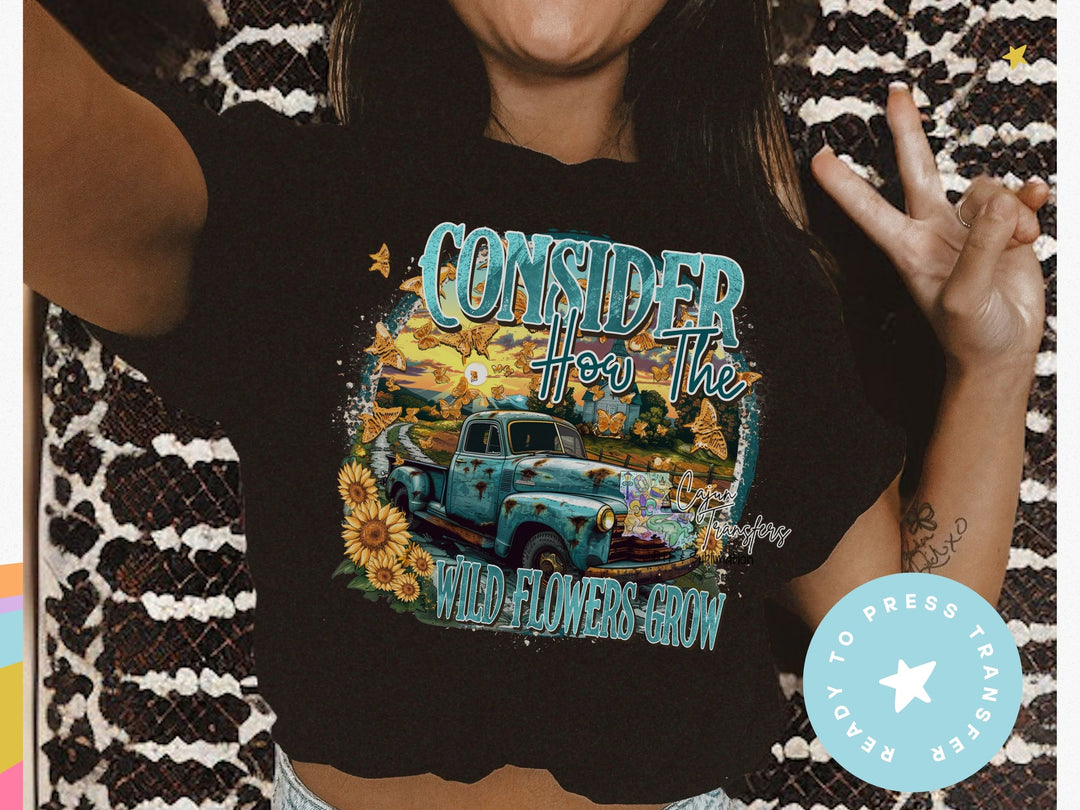 a woman wearing a black shirt with a blue truck on it