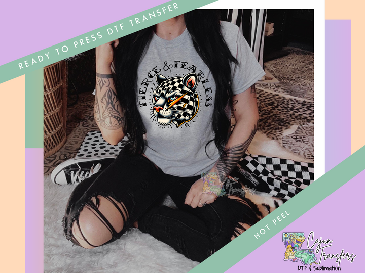 a woman sitting on the floor wearing a t - shirt with a tiger on it