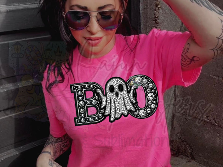 a woman wearing a pink shirt with a skull on it