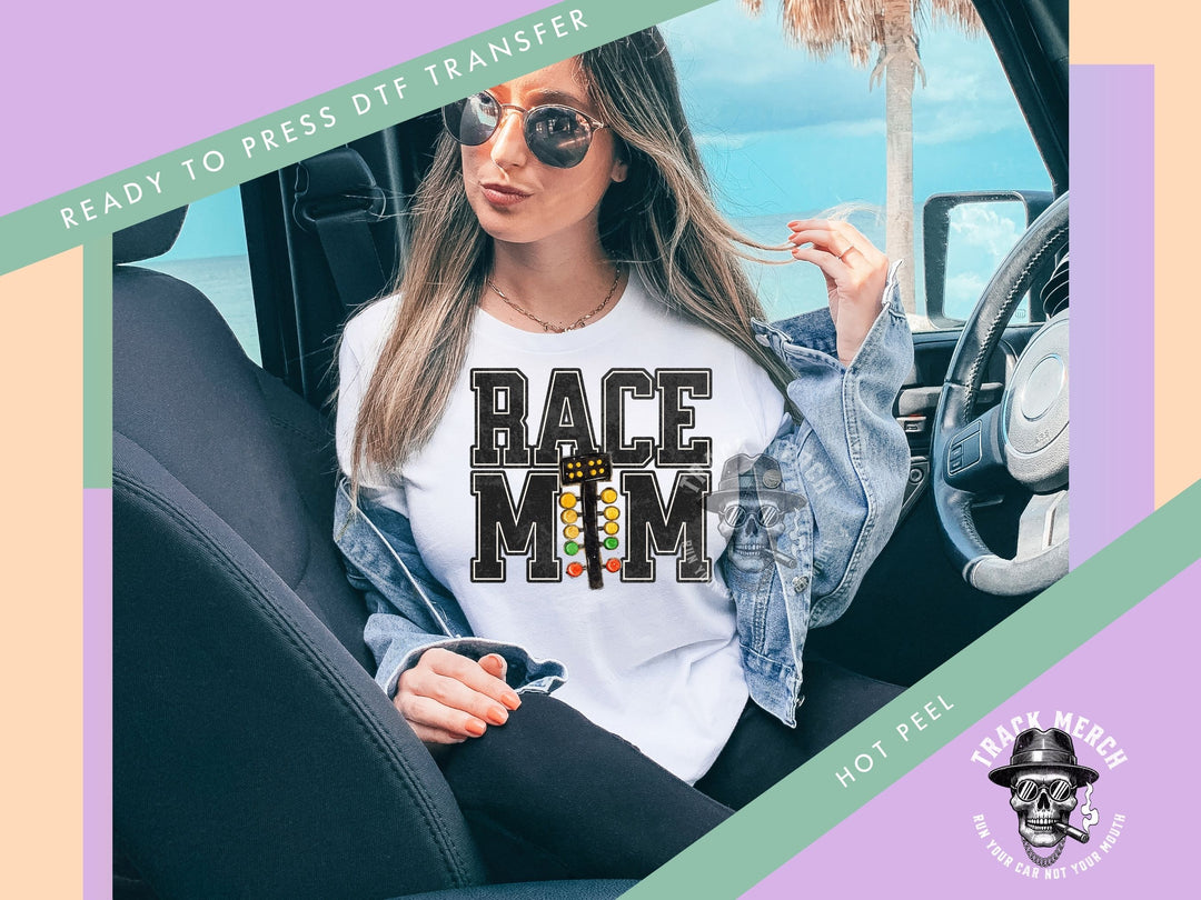 a woman sitting in a car wearing a race mom t - shirt