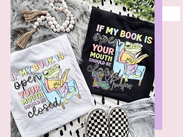 a pair of t - shirts that say if my book is your mouth should be