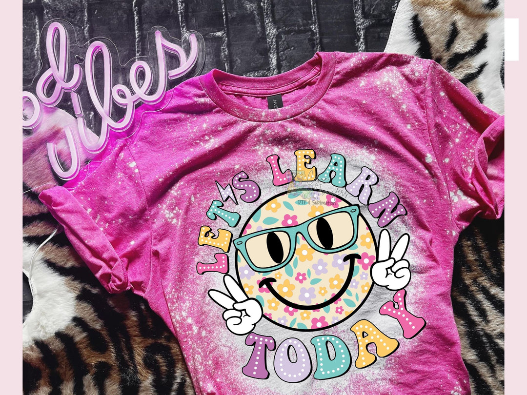 a pink shirt with a smiley face on it