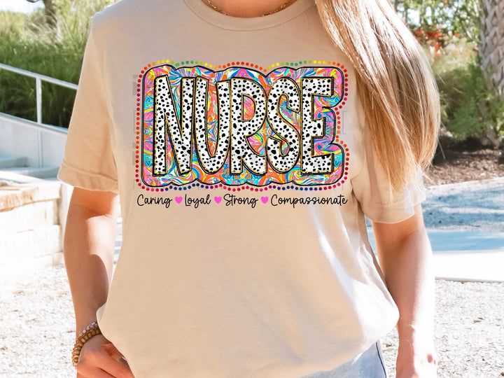 a woman wearing a nurse t - shirt with the word nurse on it