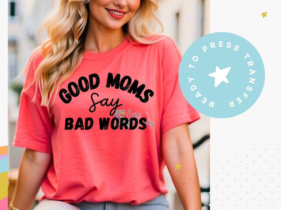 a woman wearing a pink shirt that says good moms say bad words