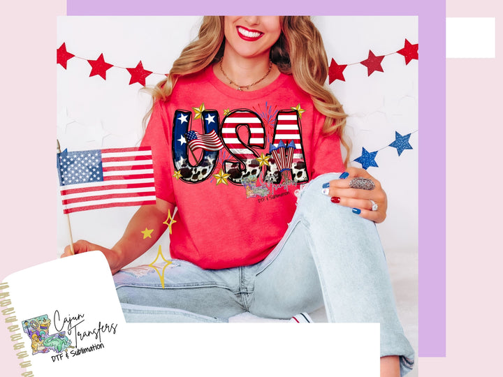 a woman sitting on the ground with an american flag