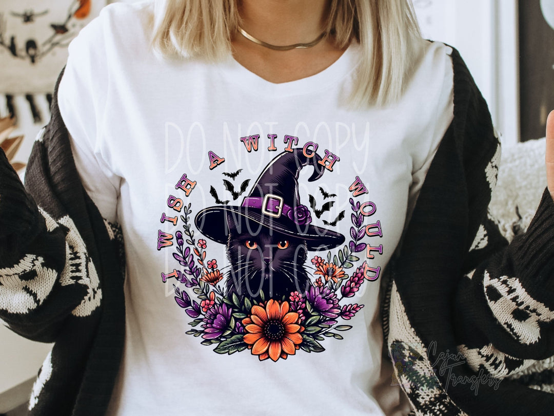 a woman wearing a white shirt with a black cat wearing a witches hat