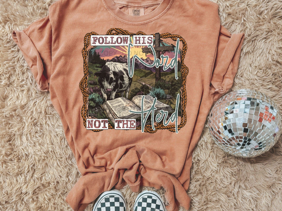 a t - shirt with a picture of a cow reading a book