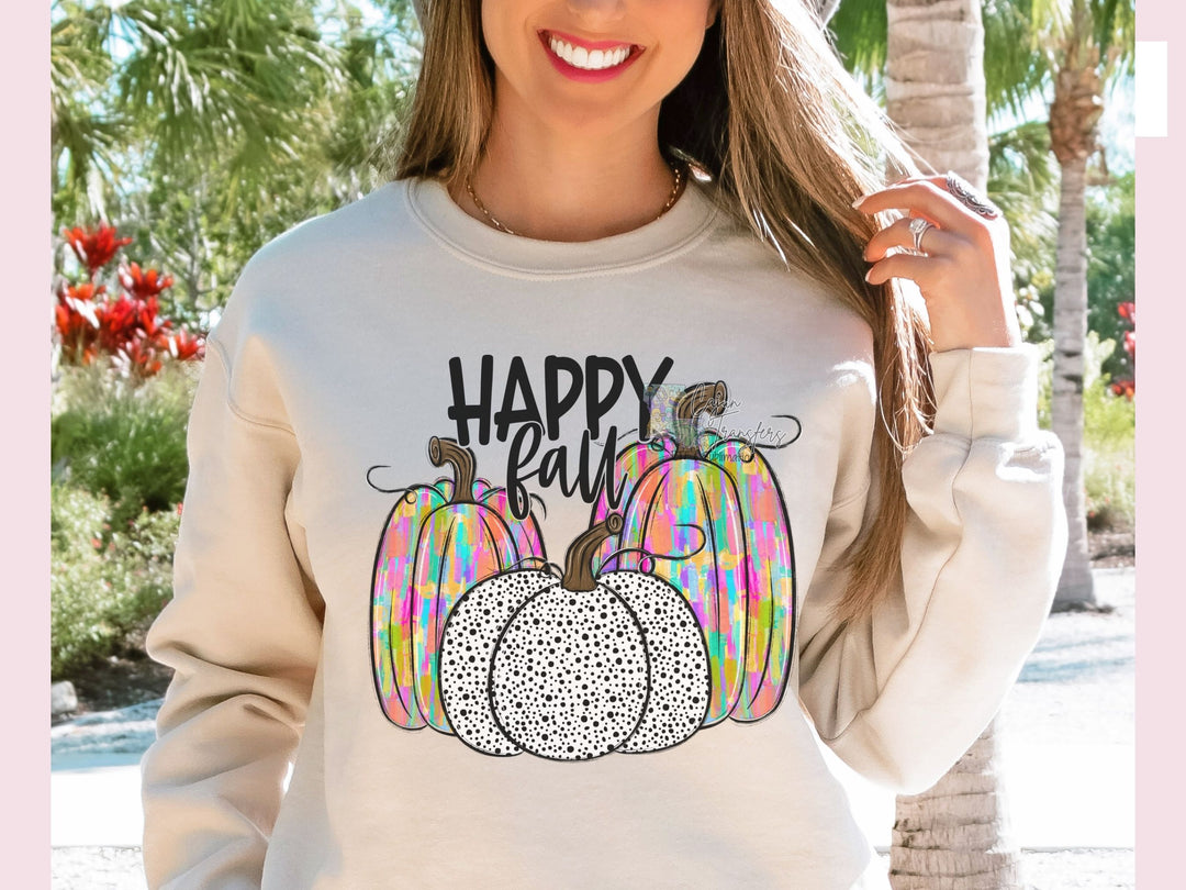 a woman wearing a happy fall sweatshirt with a pumpkin on it