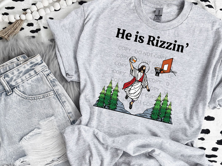 a t - shirt that says he is rizzin'on it