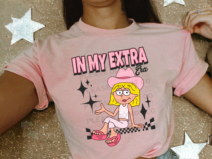 a woman wearing a pink shirt with a cartoon character on it