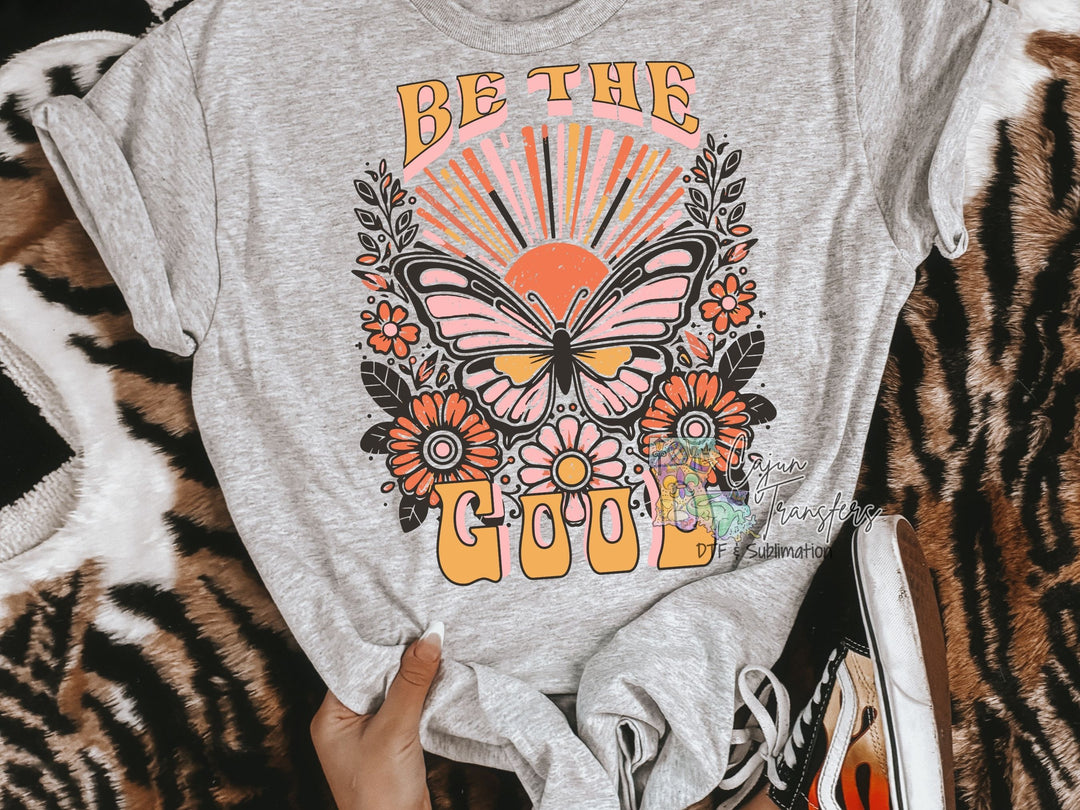 a shirt that says be the cool with a butterfly on it