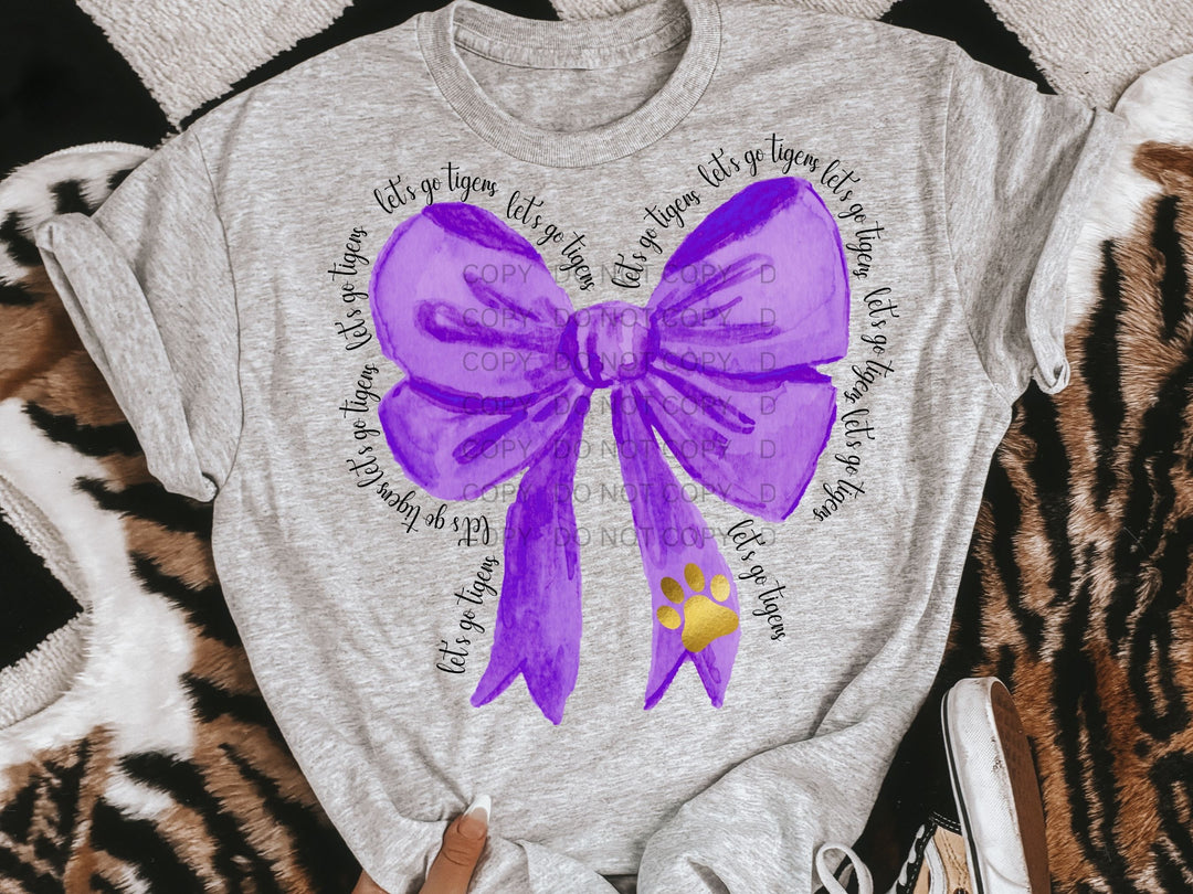 a t - shirt with a purple bow on it