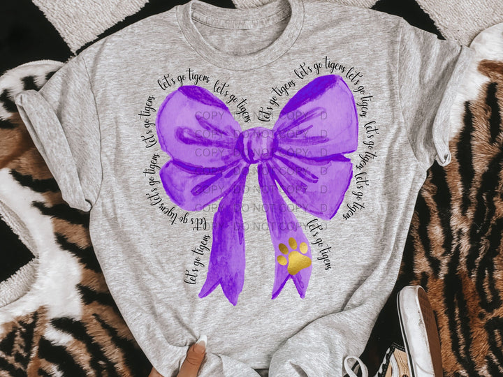 a t - shirt with a purple bow on it
