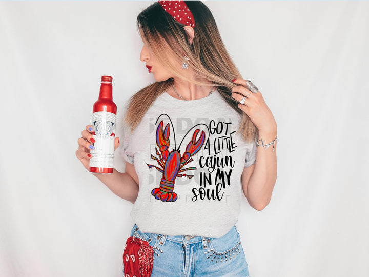 a woman holding a bottle of beer and wearing a t - shirt
