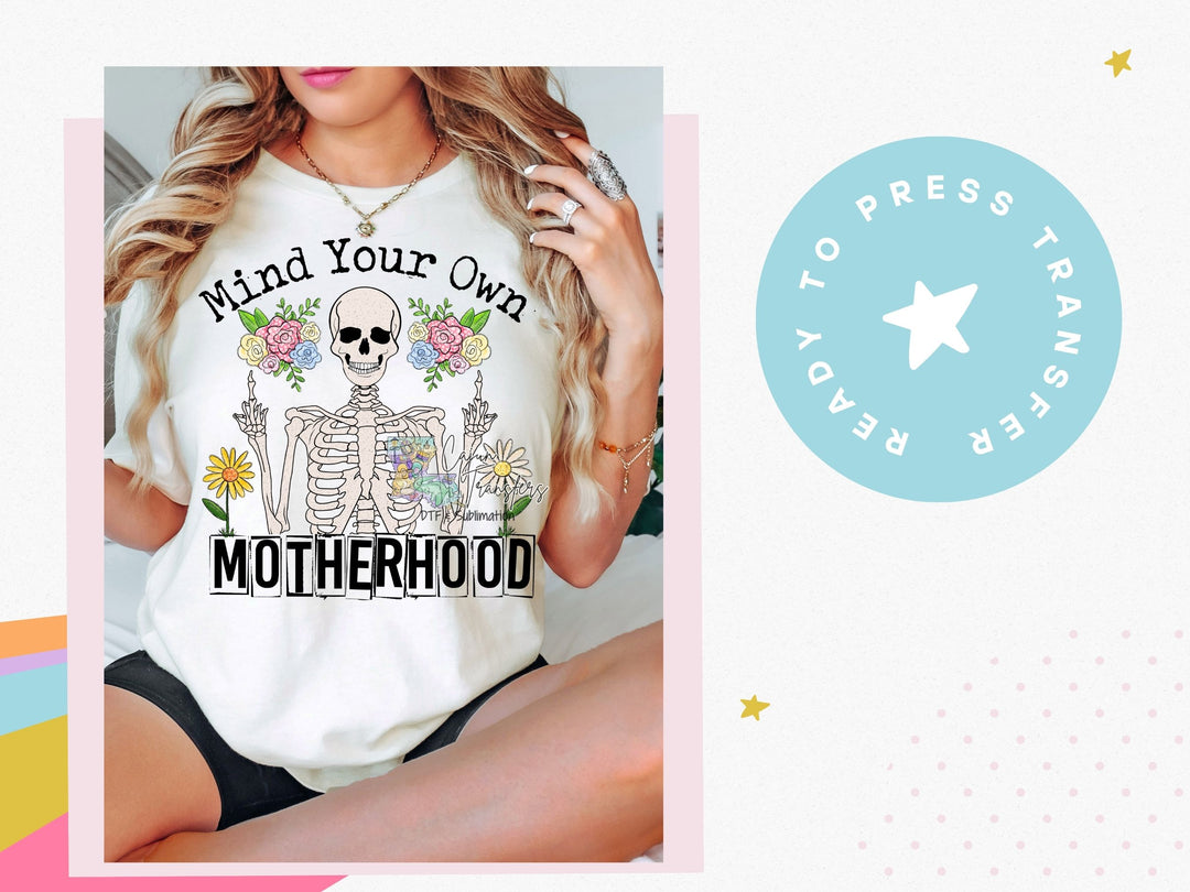 a woman wearing a t - shirt that says mind your own motherhood