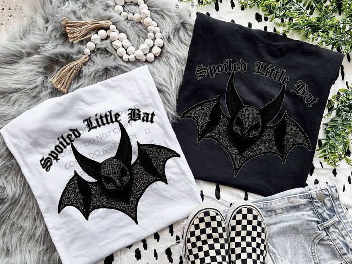 a pair of black and white shirts with bats on them