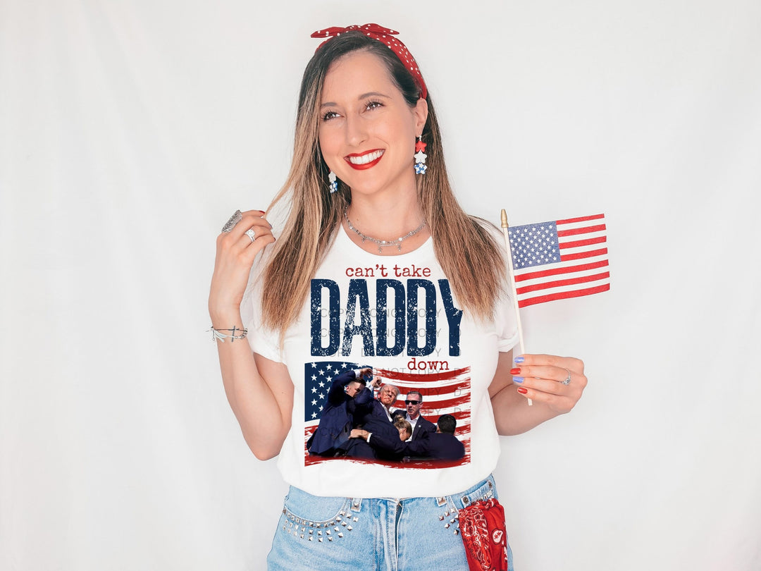 a woman holding a small american flag and a t - shirt