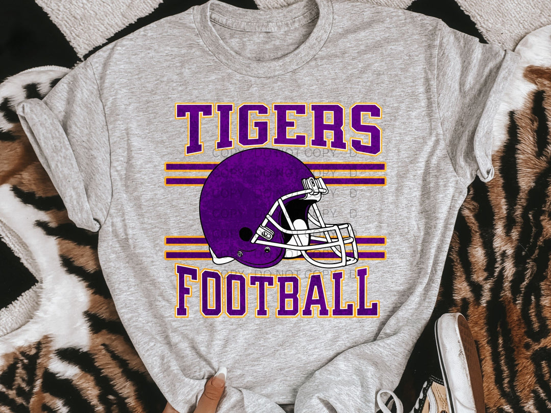 a t - shirt that says tigers football with a helmet on it