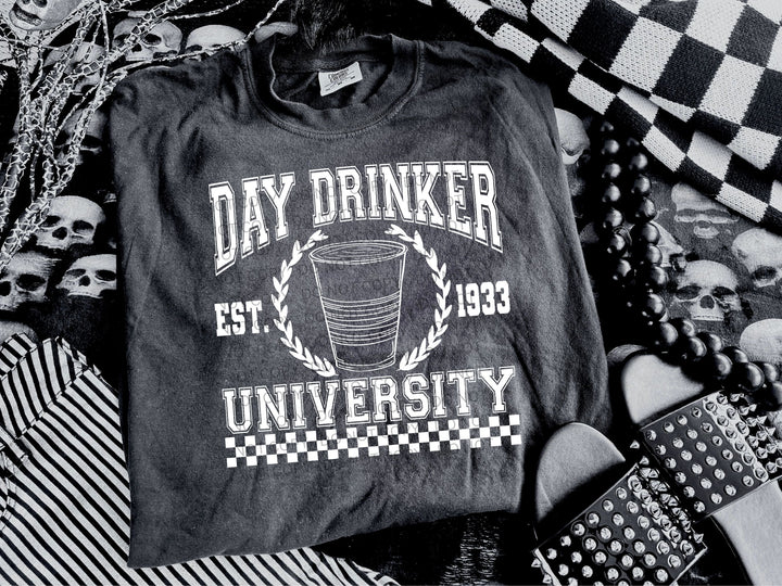 a black and white photo of a shirt with a drink on it