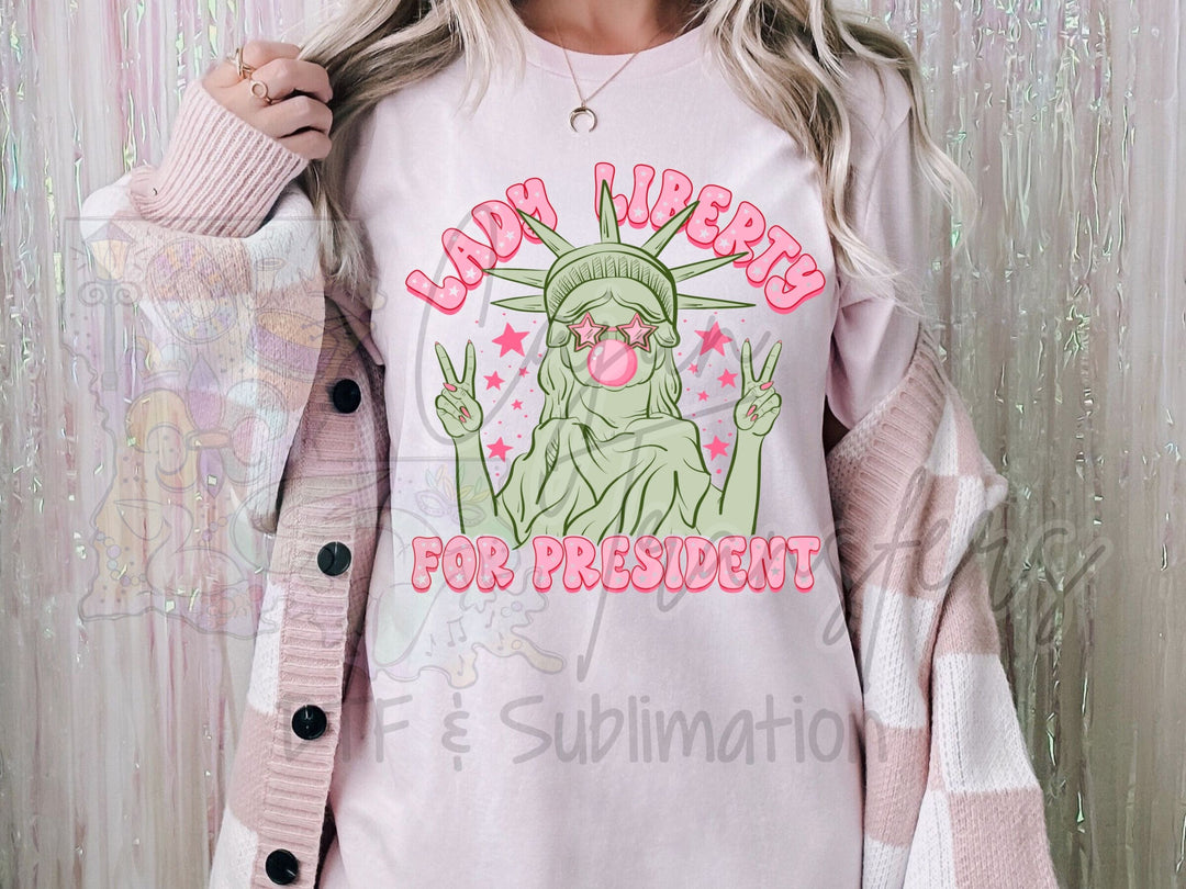 a woman wearing a pink shirt with the statue of liberty on it