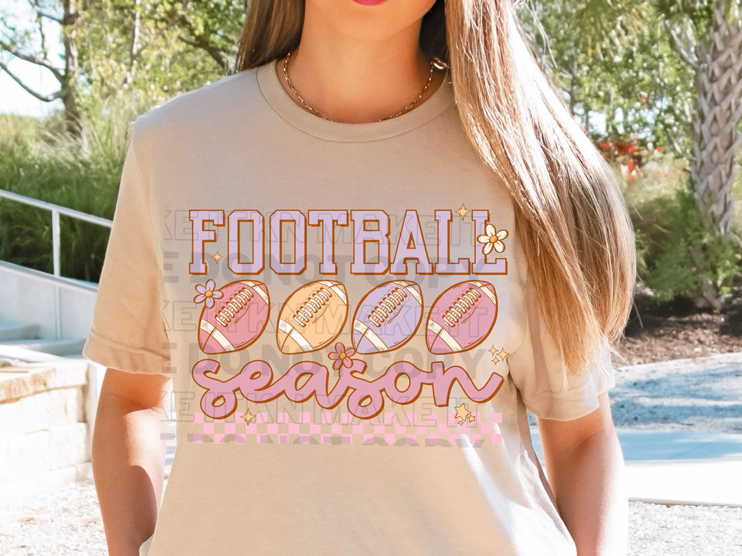 a girl wearing a football season t - shirt