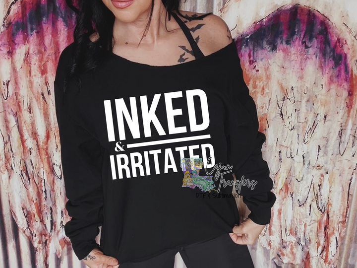 a woman wearing a black shirt that says inked and irritated