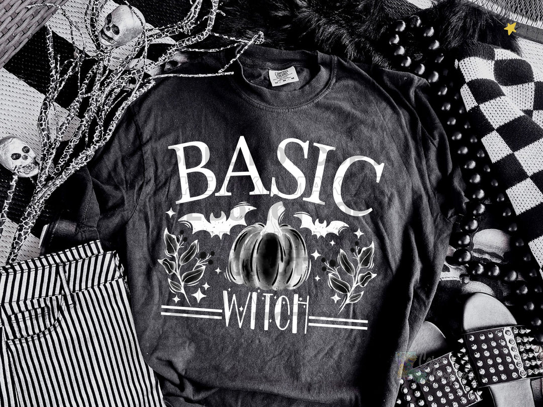 a black and white photo of a t - shirt with the words basic witch on