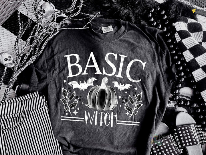 a black and white photo of a t - shirt with the words basic witch on