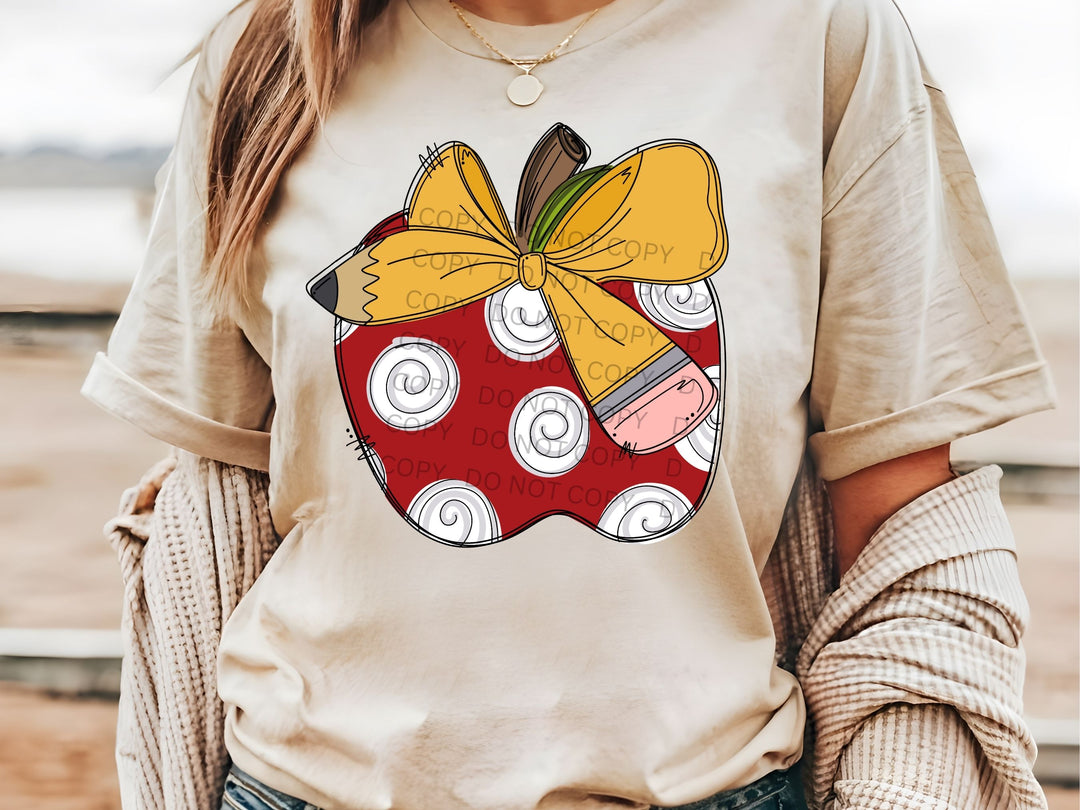 a woman wearing a t - shirt with an apple on it