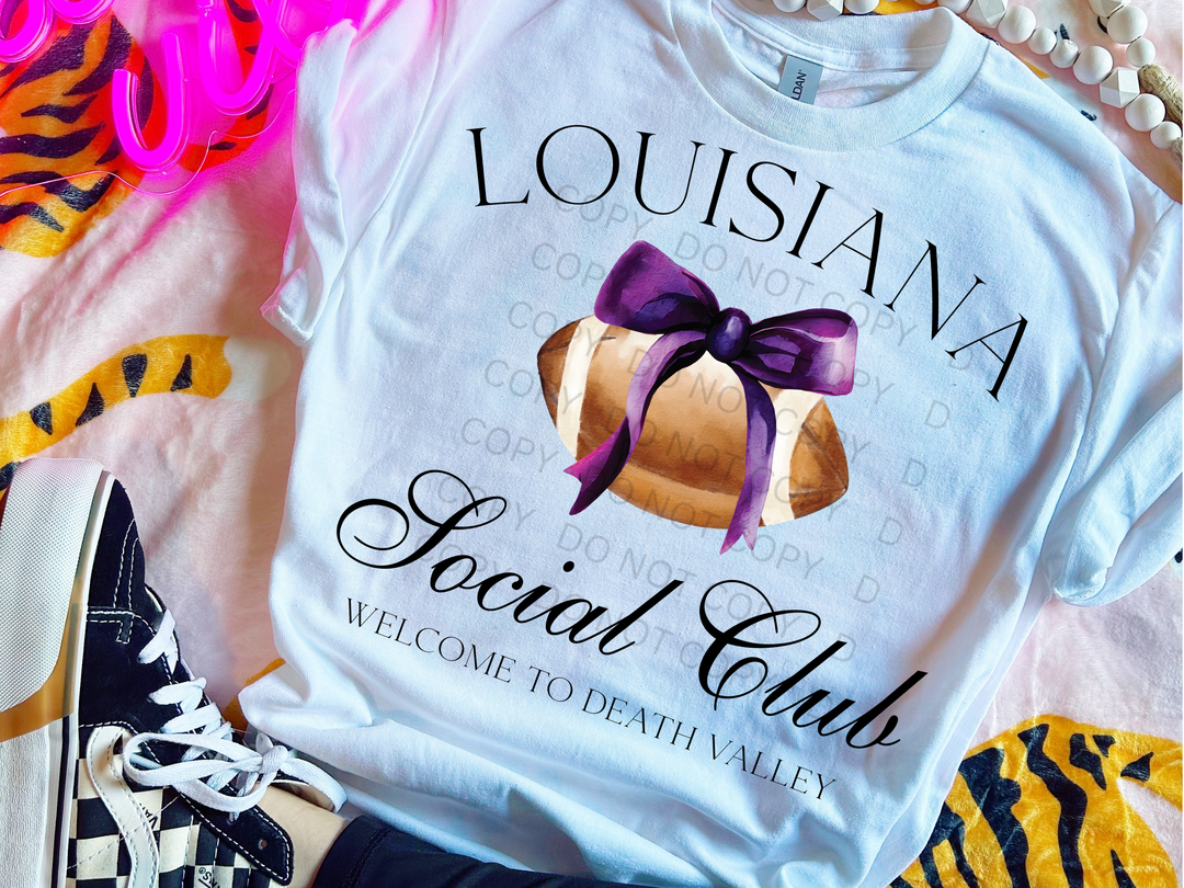 a white shirt with a purple bow on it