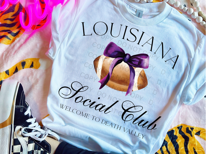 a white shirt with a purple bow on it