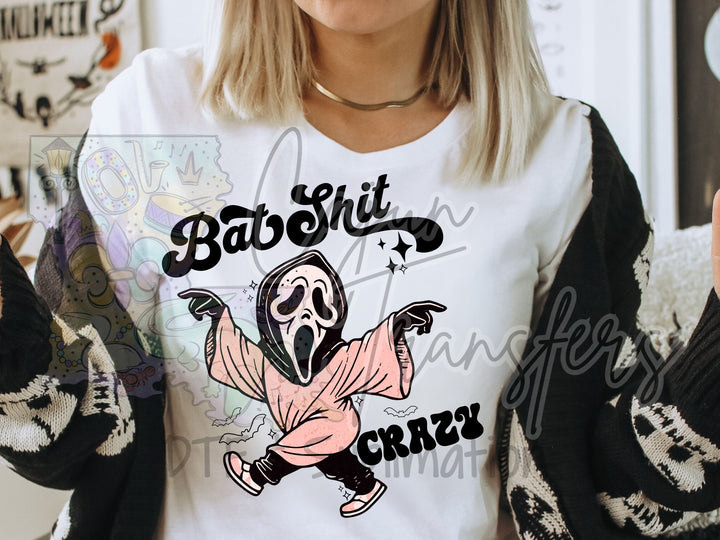 a woman wearing a t - shirt with a cartoon character on it