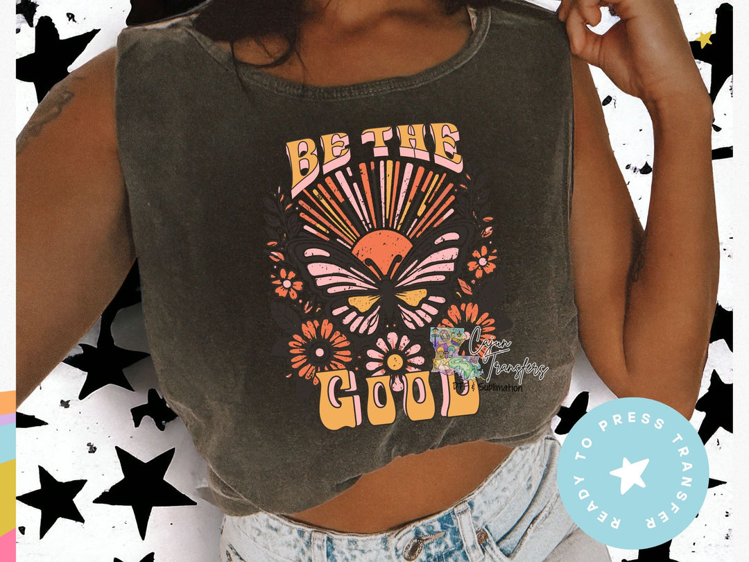 a woman wearing a crop top that says be the good