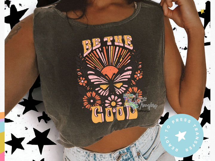 a woman wearing a crop top that says be the good