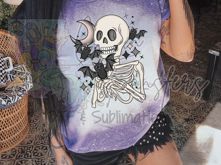 a woman wearing a purple shirt with a skeleton on it