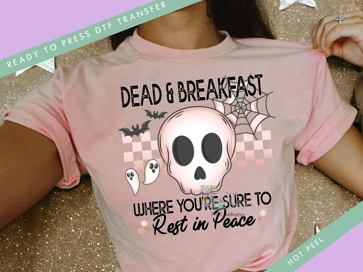 a woman wearing a pink shirt with a skull on it