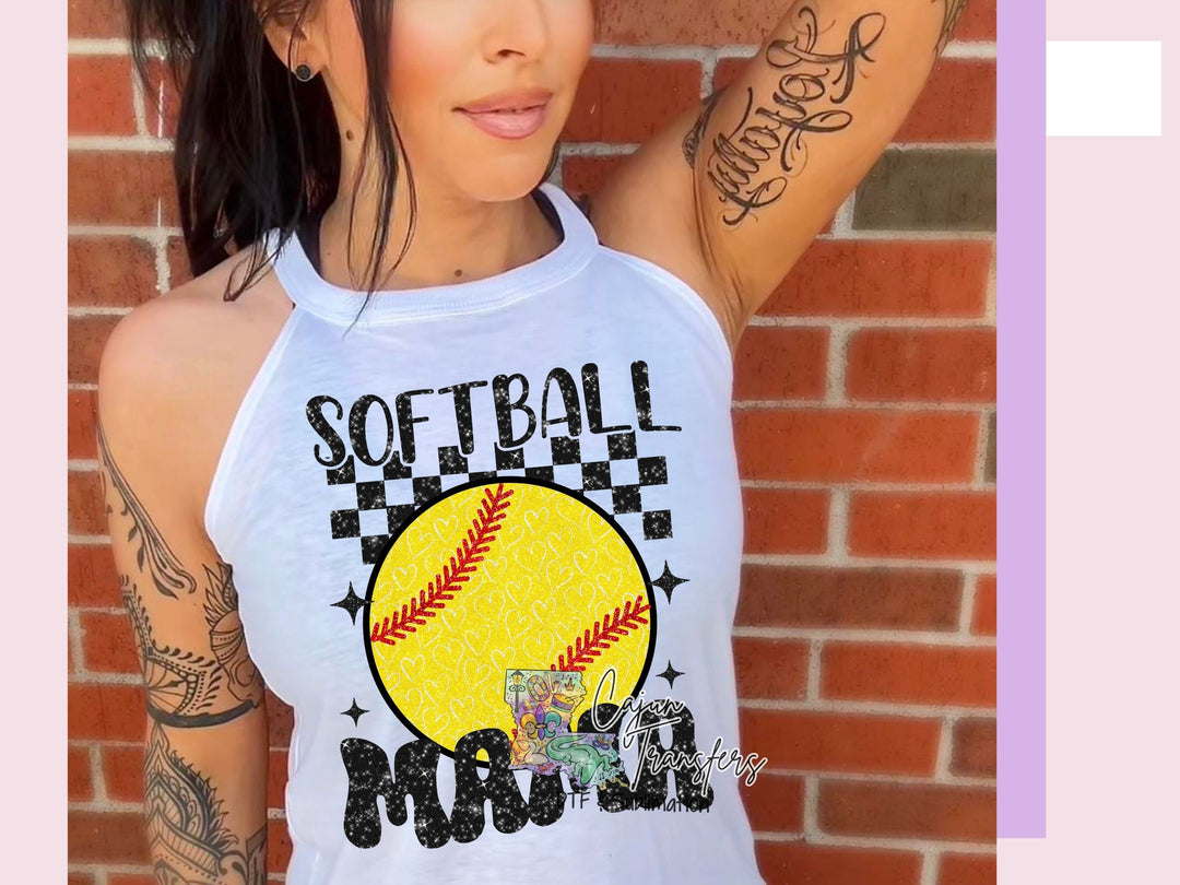 a woman wearing a softball tank top with a tattoo on her arm