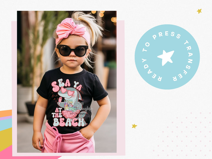 a little girl wearing sunglasses and a pink bow