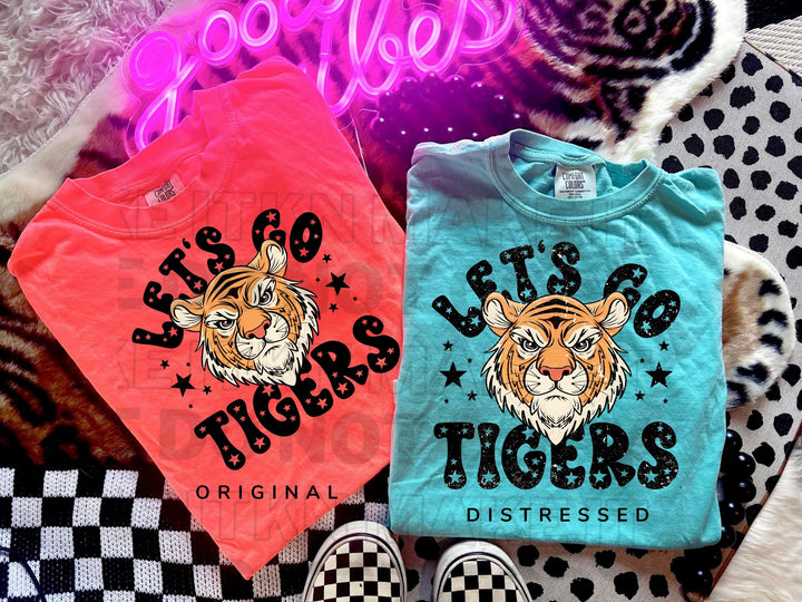 a couple of shirts that are on a bed