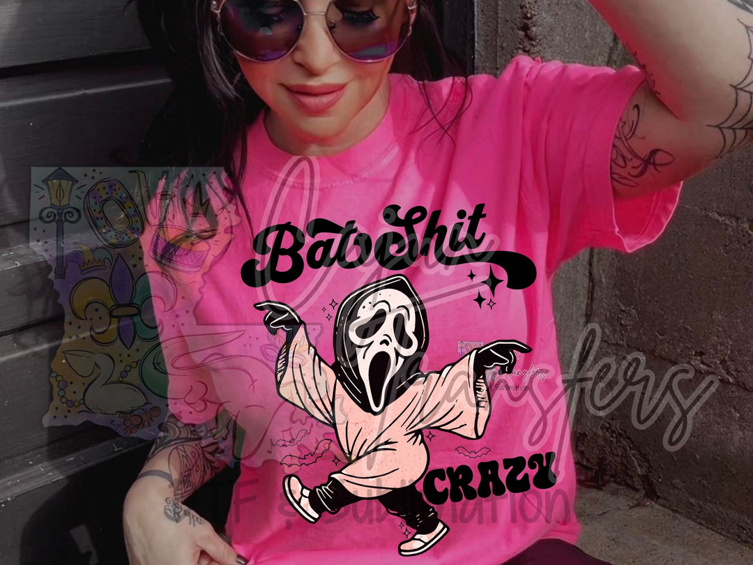 a woman wearing a pink shirt with a skeleton on it