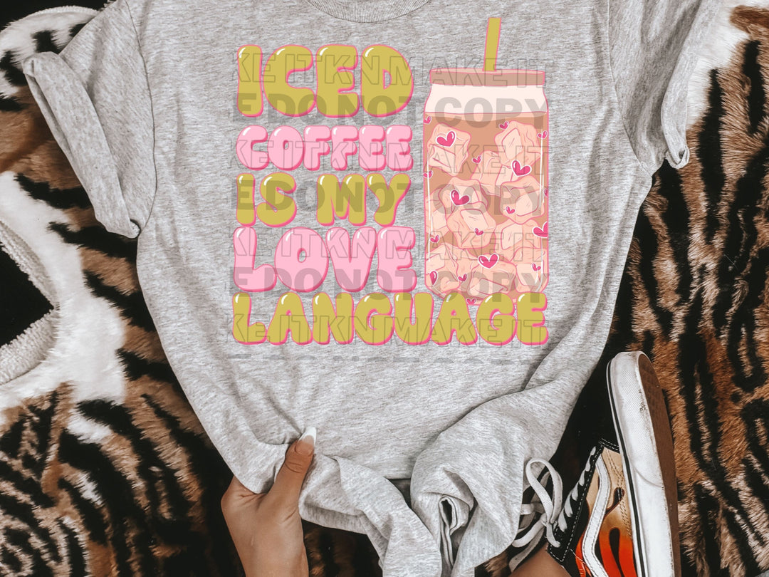 a person holding a t - shirt that says coffee is my love language