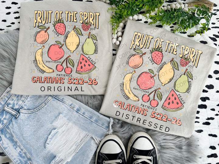 a pair of fruit of the spirit t - shirts sitting next to a pair of