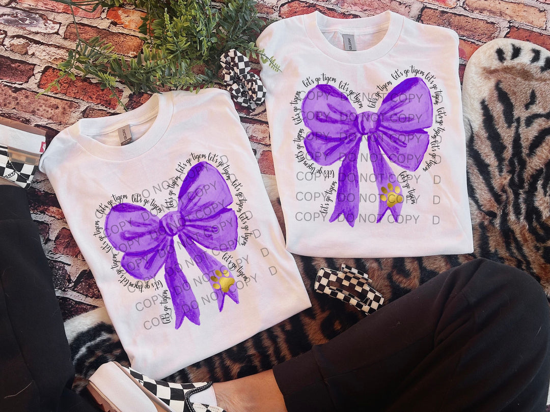 a pair of purple bows on a white shirt
