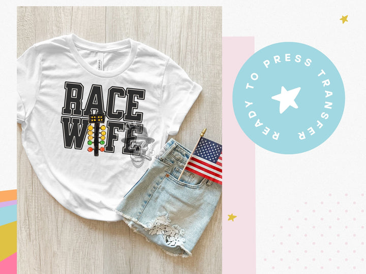 a t - shirt with the words race wife on it next to a pair of